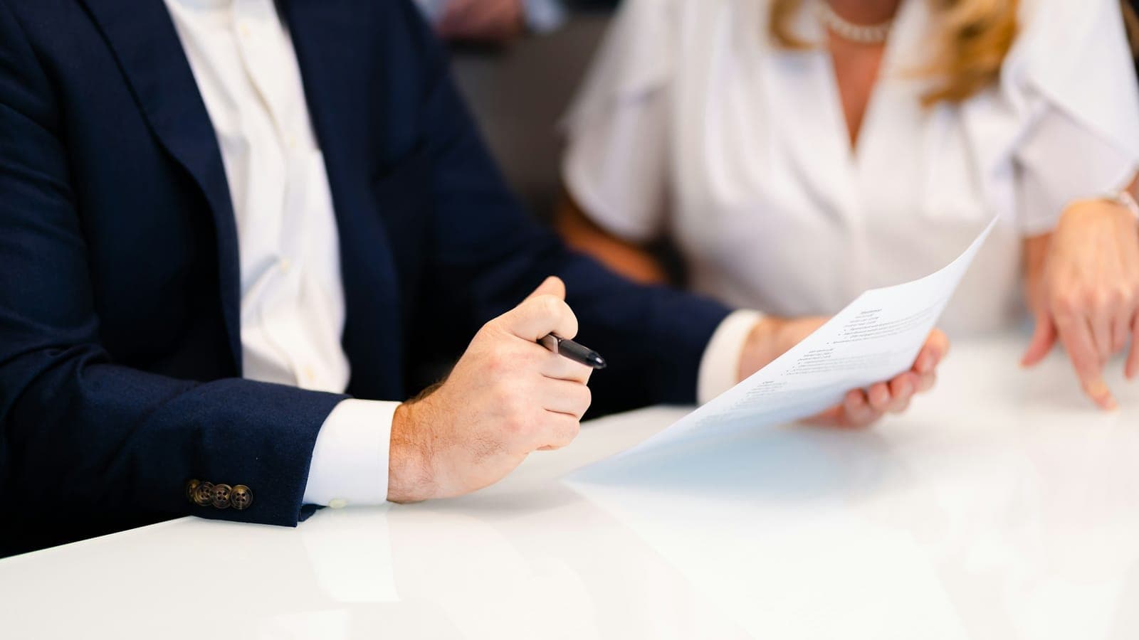 Counsel and client seated across a table in a private meeting