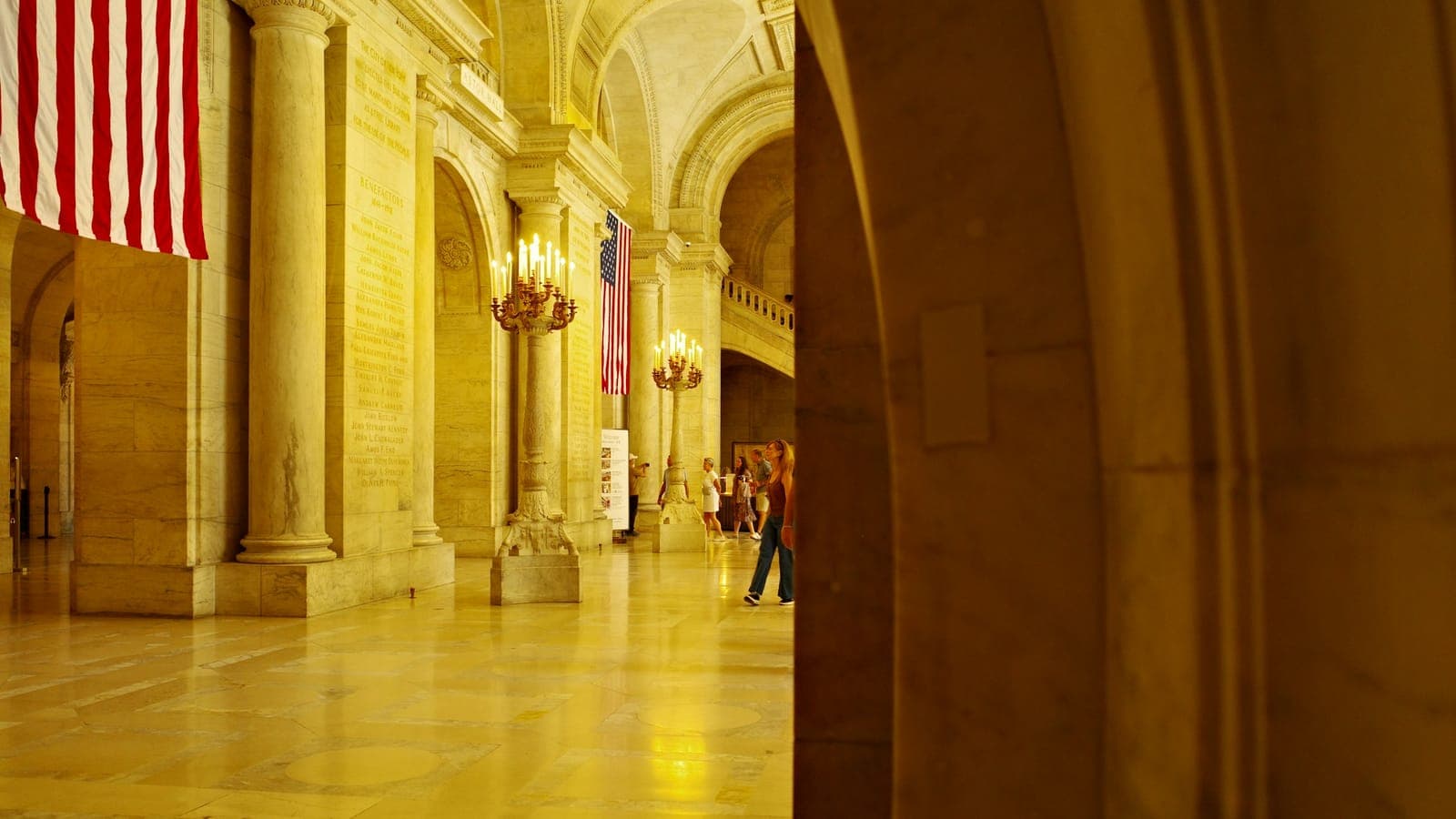Ornate civic hall with columns, arches, and chandeliers