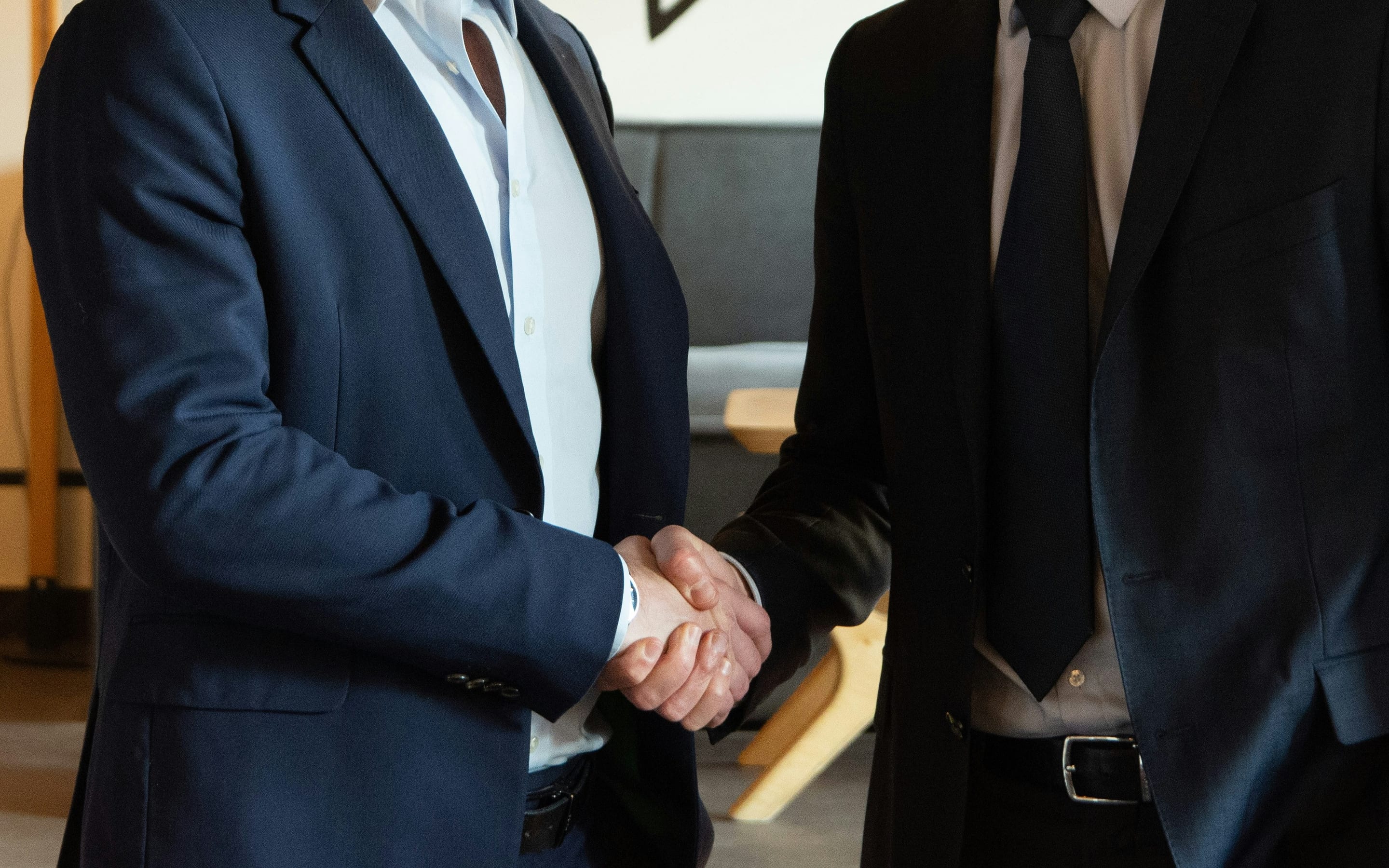 Two professionals in a standing handshake