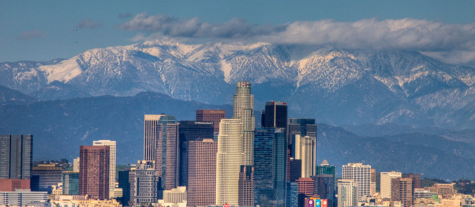 Downtown Los Angeles skyline with the snow-capped San Gabriel Mountains behind it