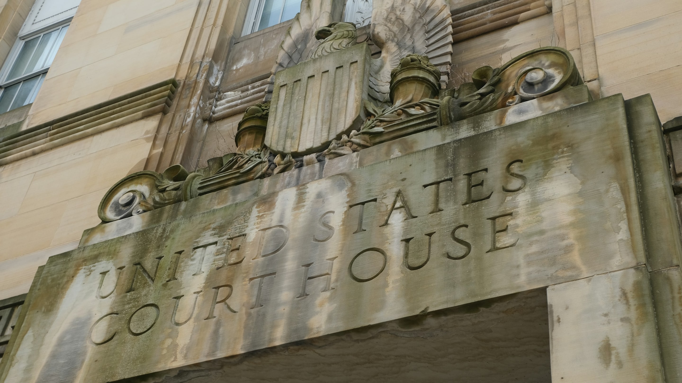 "United States Court House" carved in stone above a courthouse entrance